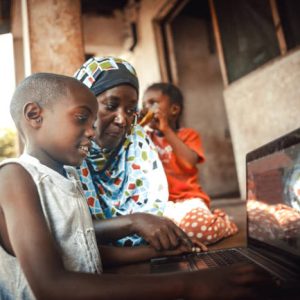 Happy  african family  together using laptop