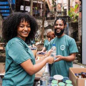 Portrait of volunteers during donation event outdoors